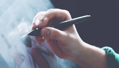 Close up of the artist's hand drawing directly on a drawing tablet